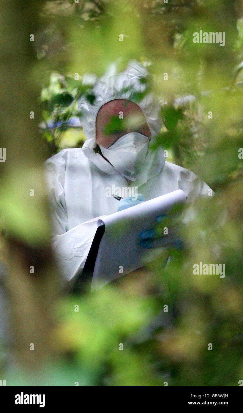 A forensics officer takes notes at the scene in Hastings, East Sussex, where a female skull was found. Stock Photo