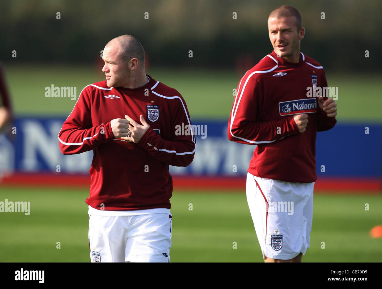 England's Wayne Rooney shows off his new hair cut to a matching David Beckham during a training session at London Colney, Hertfordshire. Stock Photo