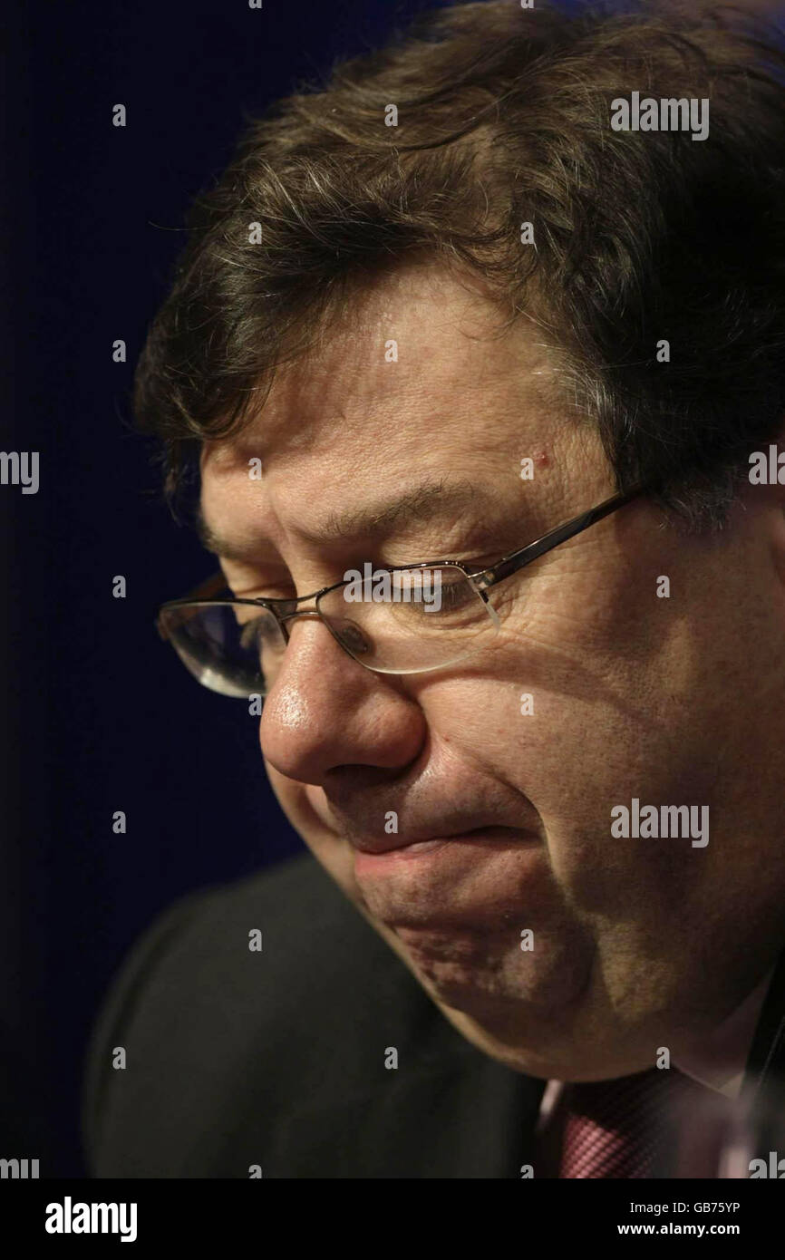 Taoiseach Brian Cowen during a press conference in Dublin, where he announced a climbdown over controversial plans to abolish automatic free health care for the over 70s. Stock Photo