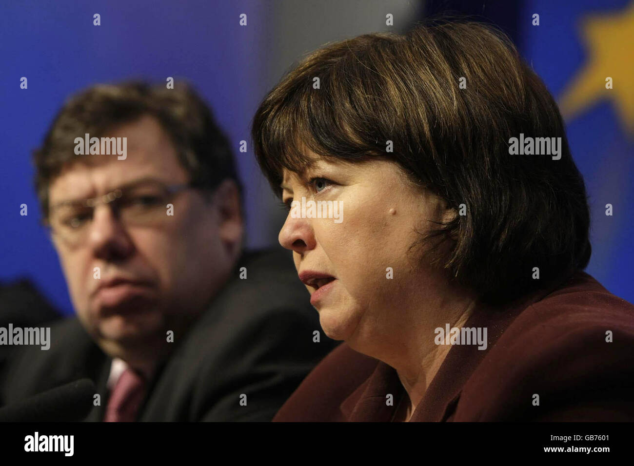 Taoiseach Brian Cowen looks on as Health Minister Mary Harney speaks at a press conference in Dublin, where the Irish government announced a climbdown over controversial plans to abolish automatic free health care for the over 70s. Stock Photo