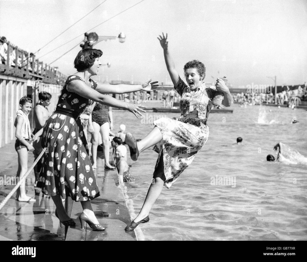Anne Wilson is pictured at the bathing pool at Great Yarmouth taking a sudden backward plunge, but she runs no risk of drowning as she is testing the new bouyant swimsuit. The swimsuit is the invention of Mark Shaw, which has air panels to keep the wearer afloat face-up. Stock Photo
