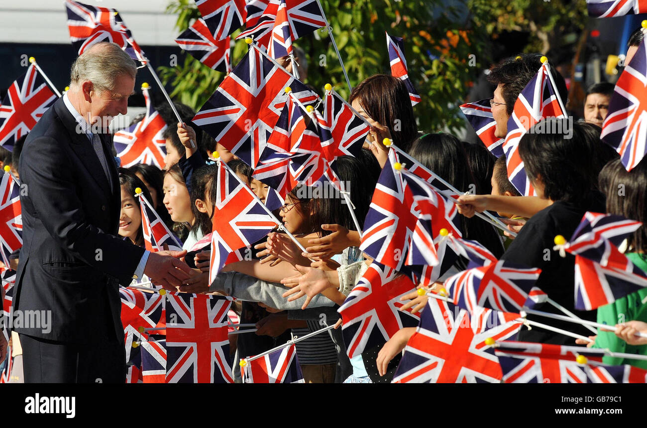 The Prince of Wales is greeted by flag-waving school children, as he arrives at the Museum of Science and Innovation, in central Tokyo, this afternoon. Stock Photo