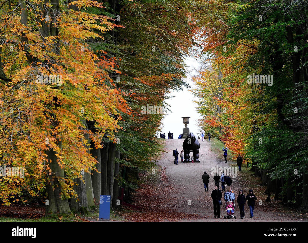 Visitors to Chatsworth House in the Peak District, enjoy the autumn colours in the house grounds. Stock Photo