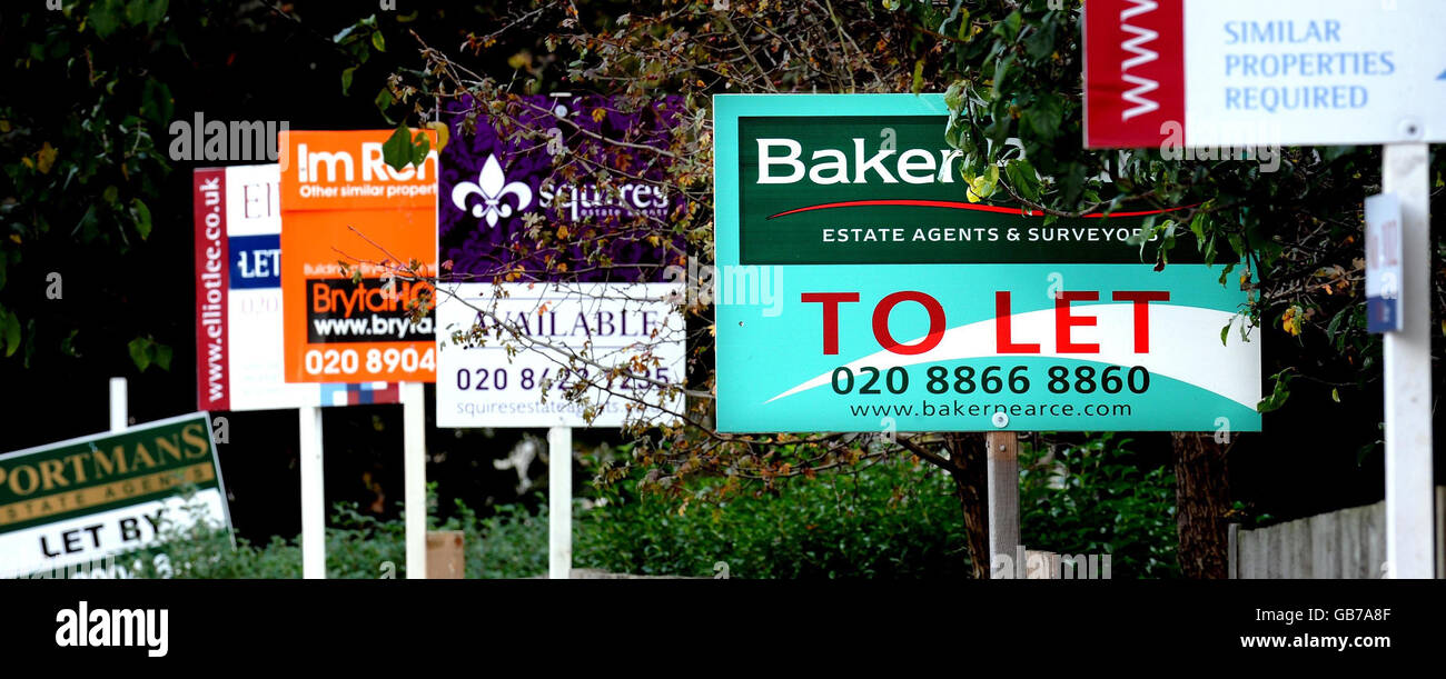 To let and for sale property boards on Watford Road in Sudbury, London. The annual rate at which house prices in England and Wales are falling nearly doubled during September to hit a record of 8%, figures showed today. Stock Photo