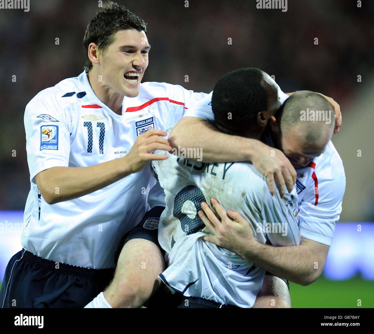 England's Wayne Rooney (right) celebrates his goal with Emile Heskey and Gareth Barry (left) during the FIFA World Cup Qualifying match at the Dinamo Stadium, Minsk, Belarus. Stock Photo