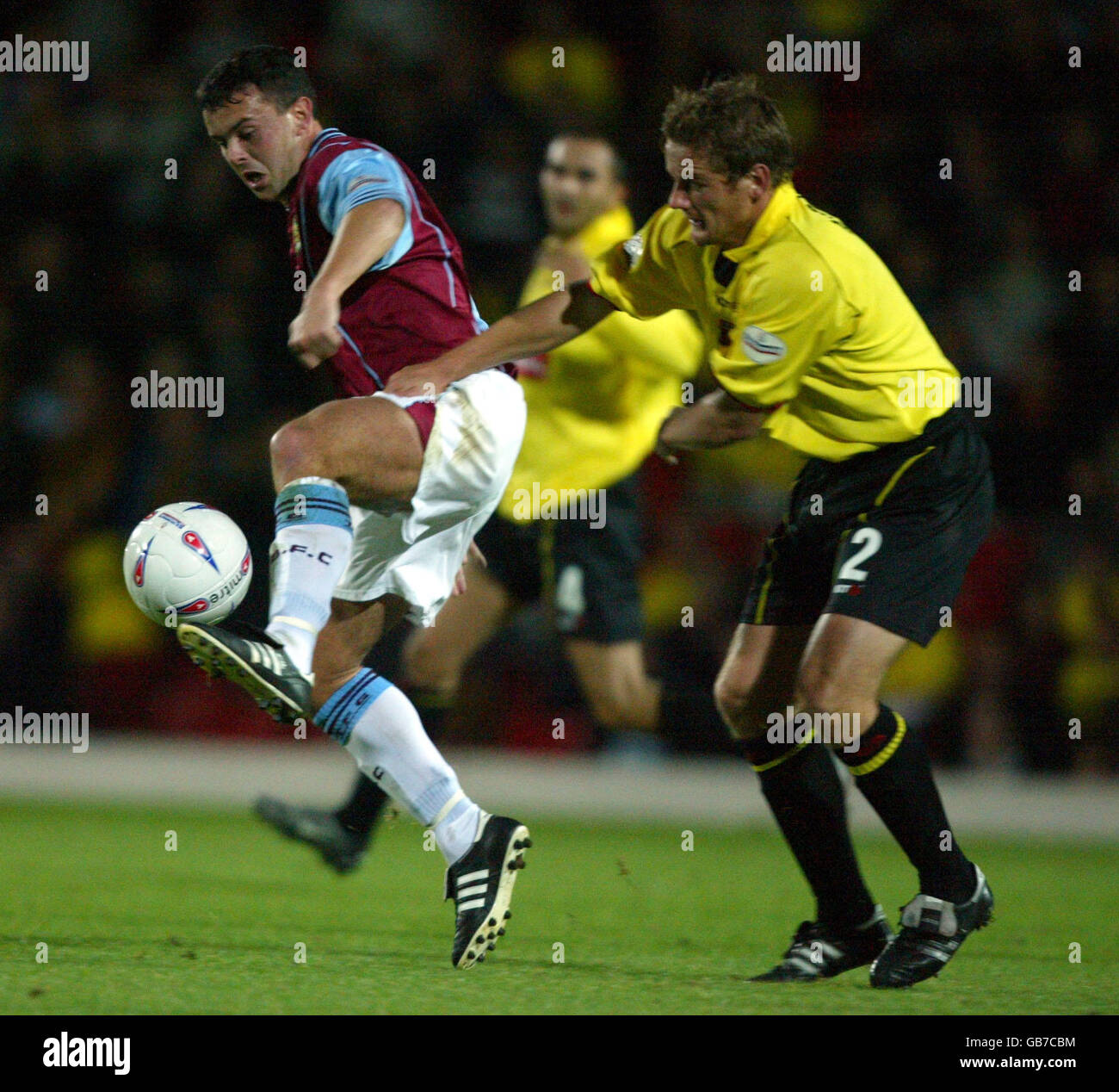 Burnley's Paul Weller and Watford's Neal Ardley battle for the ball Stock Photo