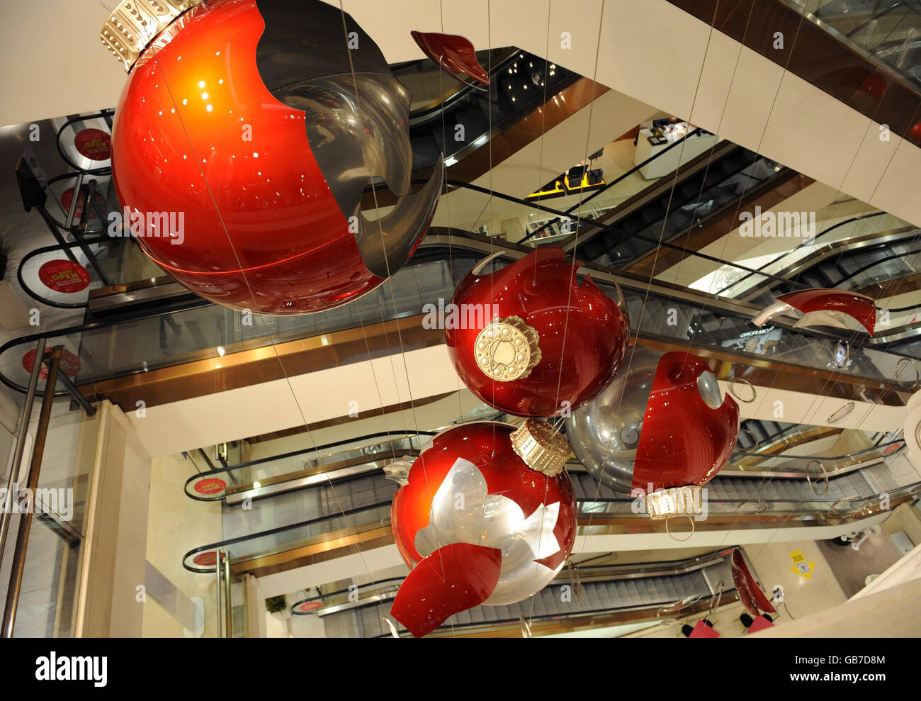 Giant red baubles in Selfridges department store in central London go on display. They are part of an artwork by Claire Morgan and form part of this year's Christmas decorations. Stock Photo
