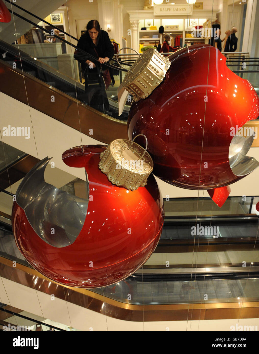 Giant red baubles in Selfridges department store in central London go on display. They are part of an artwork by Claire Morgan and form part of this year's Christmas decorations. Stock Photo
