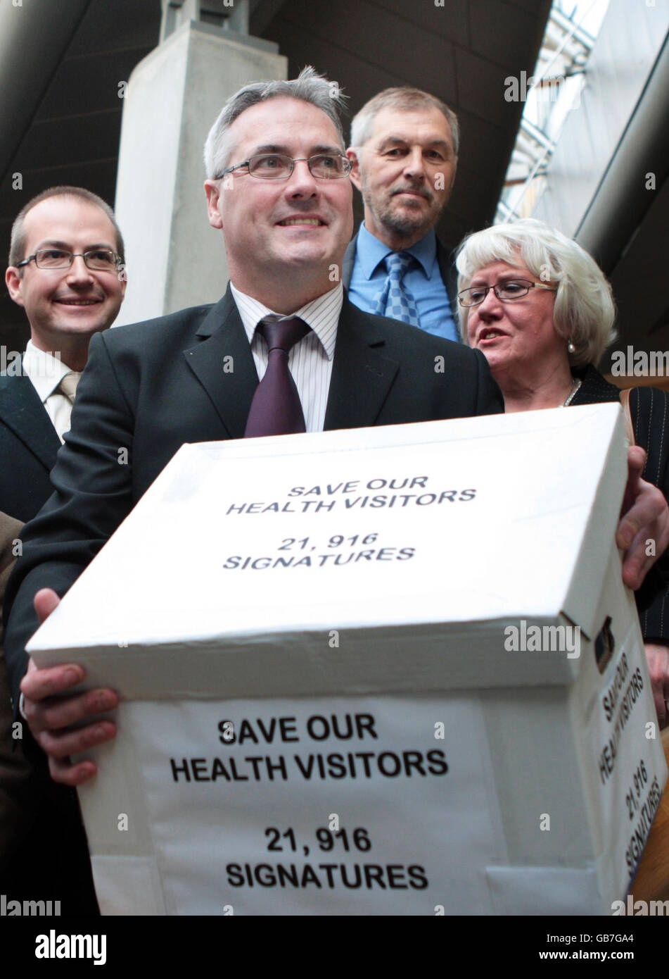 Frank McAveety MSP delivers a petition to the Scottish Parliament from a delegation of Glasgow doctors who are opposed to the removal of health visitors from GP practices. Stock Photo