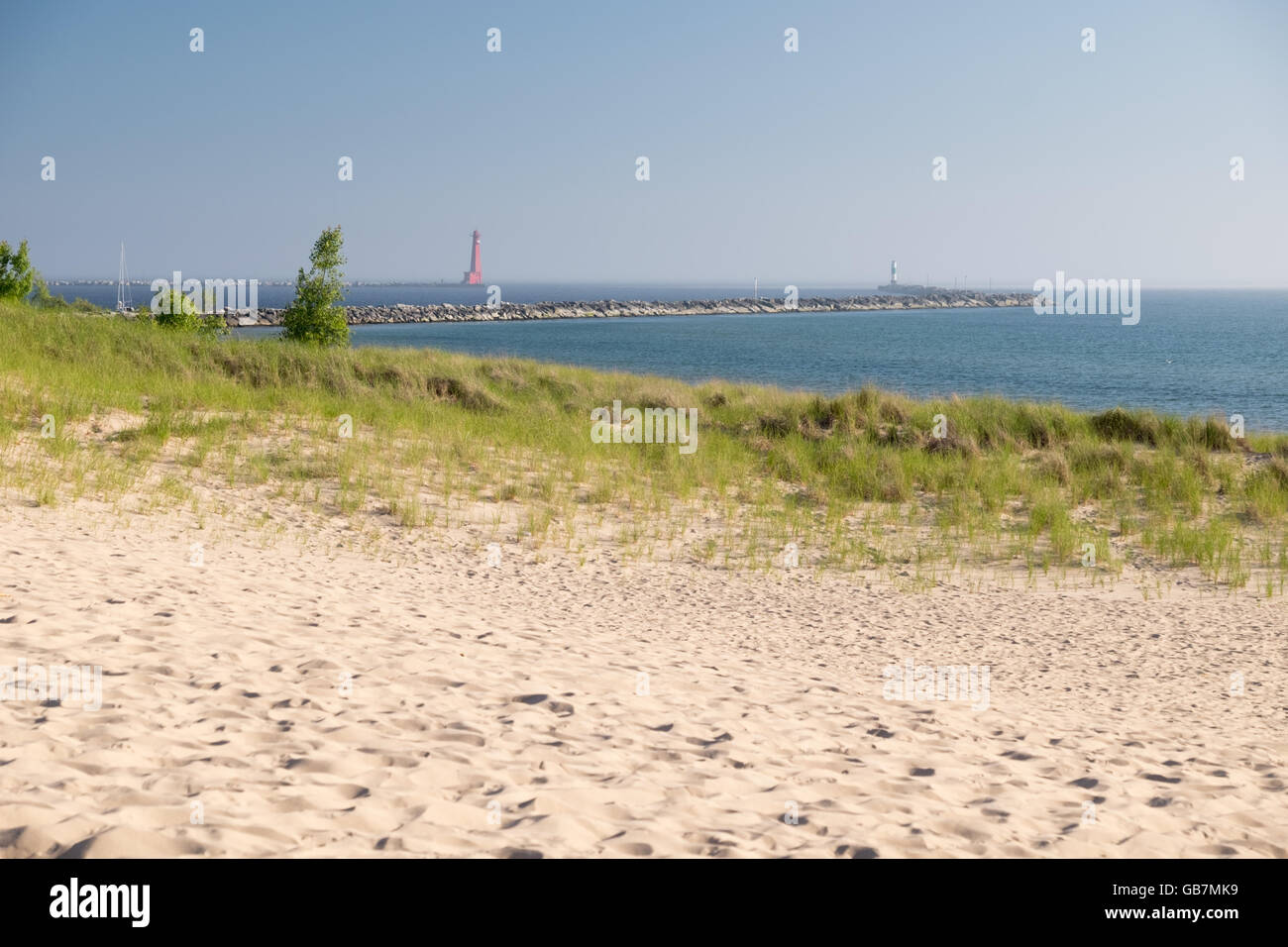 Sand dunes and dune grass on the shore of Lake Michigan at Muskegon State Park. In the background are the lighthouse and channel Stock Photo