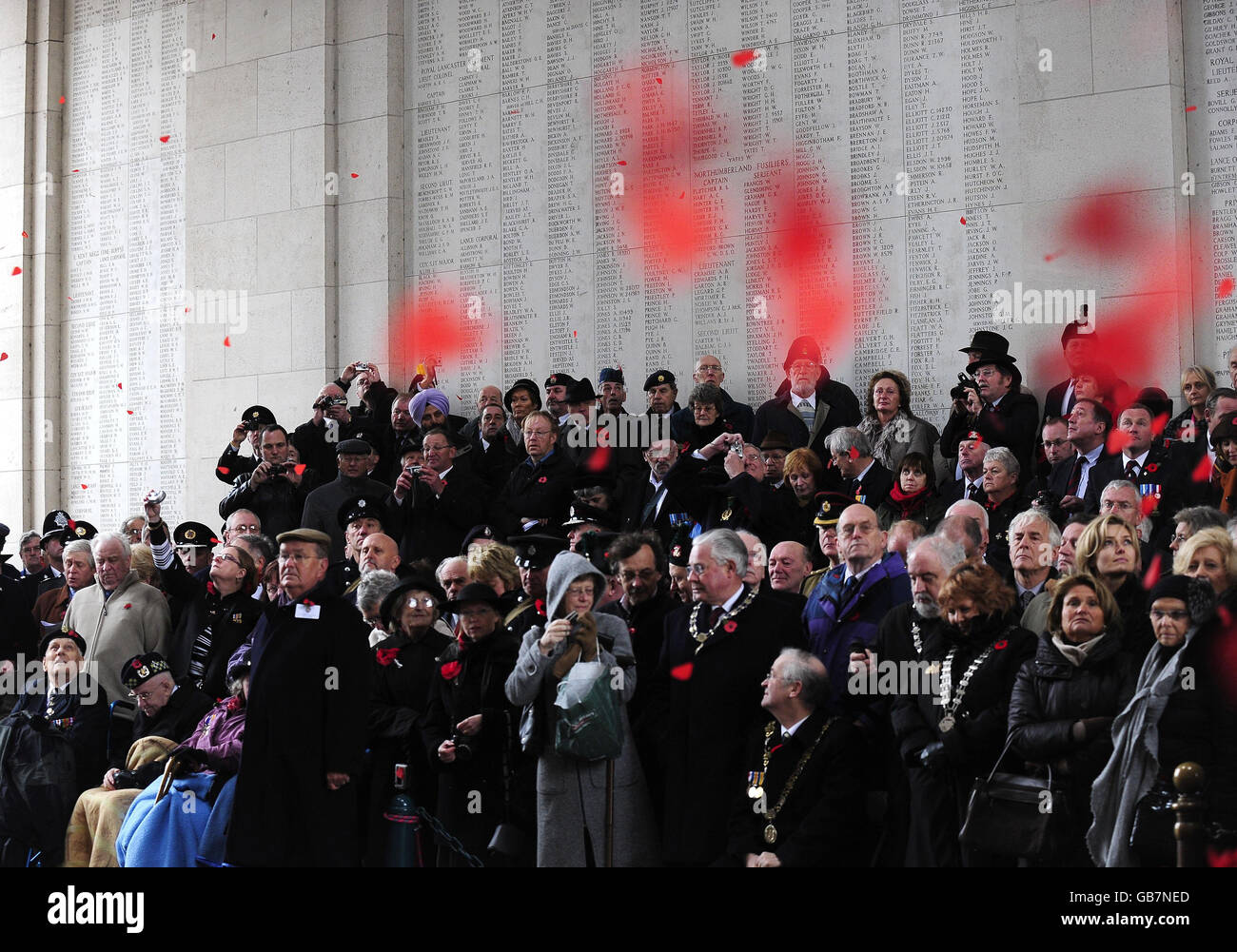 Poppies fall over those attending a Remembrance Service for British and Commonwealth soldiers who were killed in the Great War after a Remembrance Service at the Menin Gate in Ypres, Belgium to mark the 90th Anniversary of the end of the Great War. Stock Photo