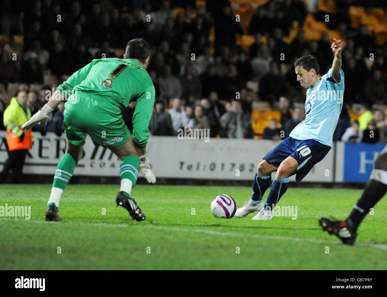 Brentford's Charlie MacDonald (right) scores during the Coca-Cola Football League Two match at Vale Park, Port Vale. Stock Photo