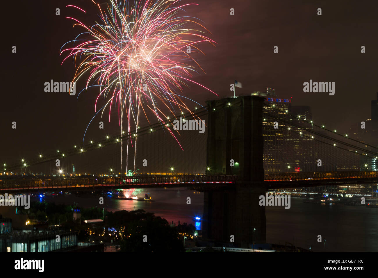 New York, NY USA - July 4, 2016: View of 40th annual Macys 4th of July fireworks on East River with Brooklyn bridge on foreground Stock Photo