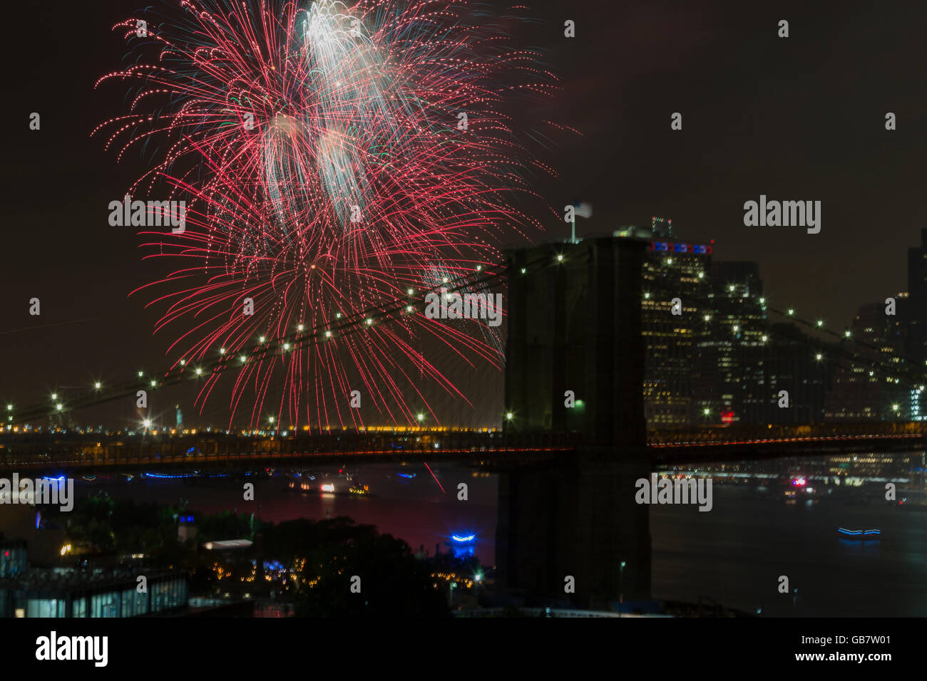 New York, NY USA - July 4, 2016: View of 40th annual Macys 4th of July fireworks on East River with Brooklyn bridge on foreground Stock Photo