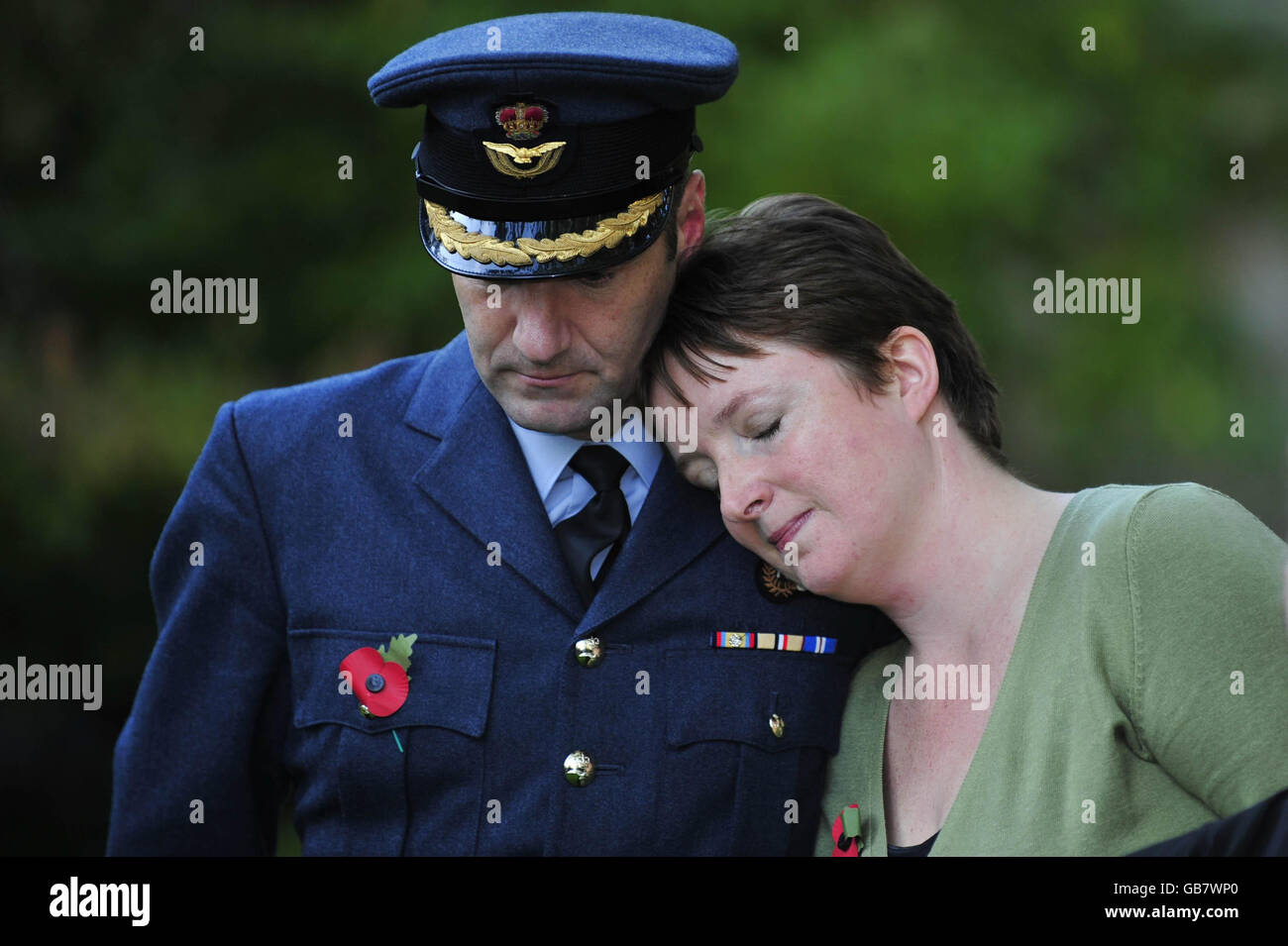 Sarah Chapman, who lost her brother Bob O'Connor, and RAF Lyneham station  commander Group Captain Mike Neville console each other during a press  conference after the inquest into the death of 10