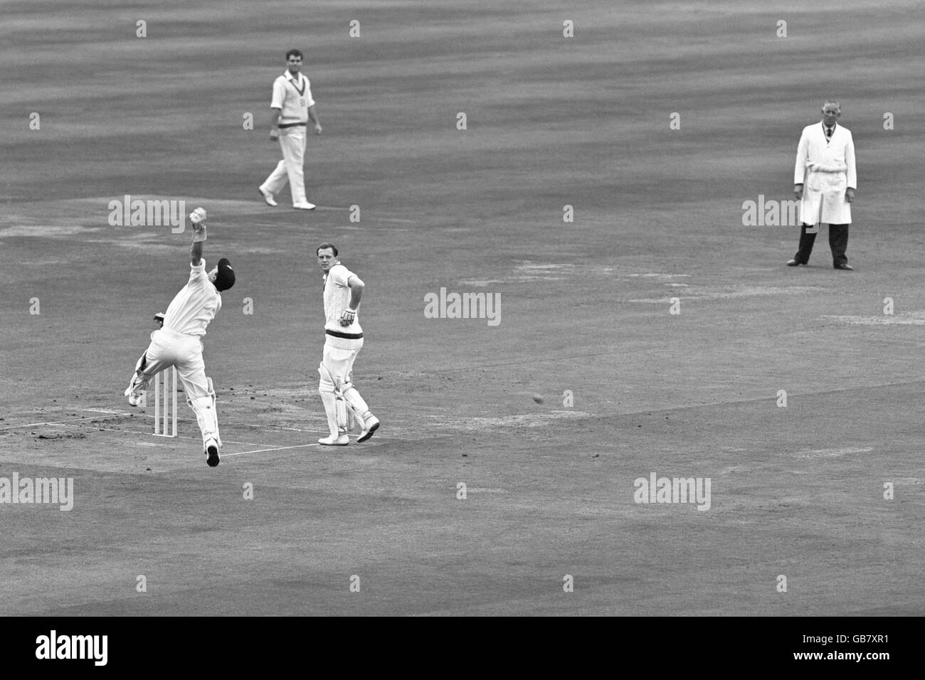 John Murray, the Middlesex wicketkeeper leaps for a high return with batsman Geoffrey Boycott watching. Stock Photo