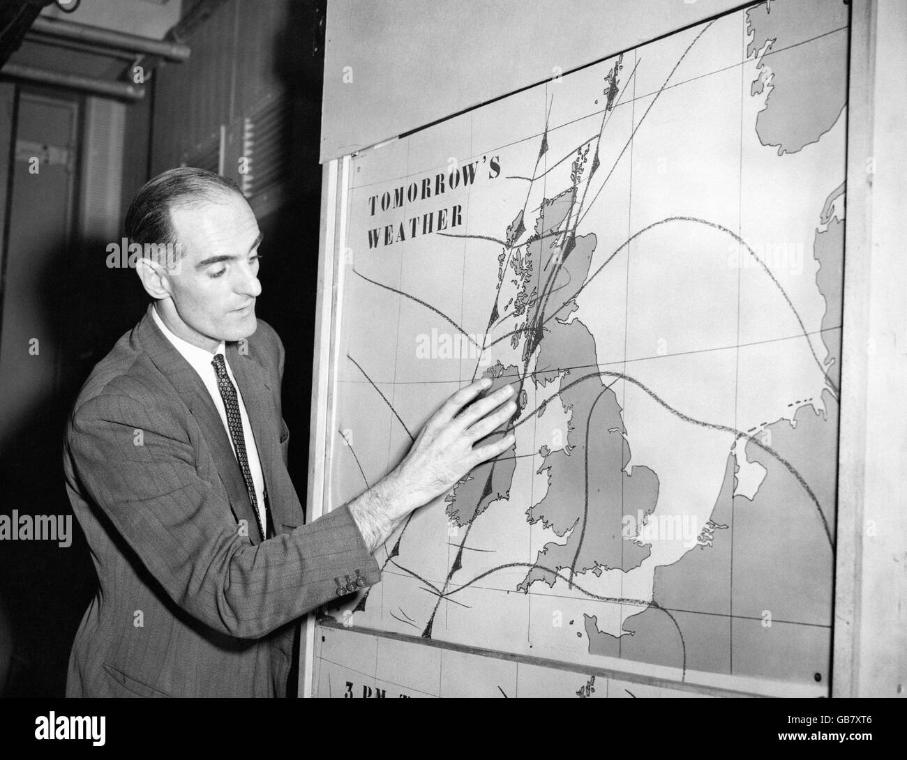 TV's new weather man George Cowling, making his first appearance in the weather programme televised from Lime Grove Studios, London. He has been introduced in an effort to brighten presentation of the weather news. Stock Photo