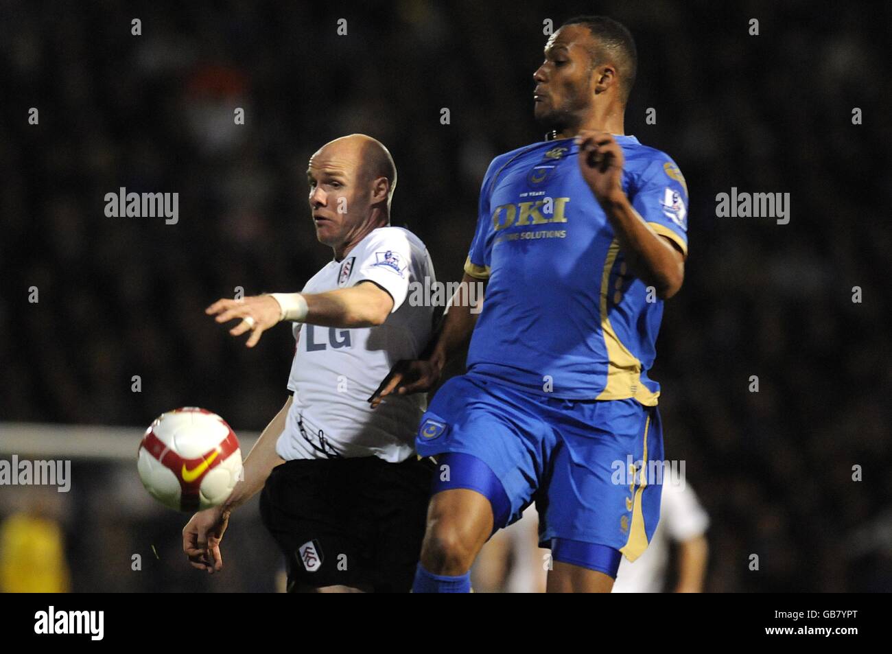 Fulham's Andrew Johnson (left) and Portsmouth's Younes Kaboul battle for the ball. Stock Photo