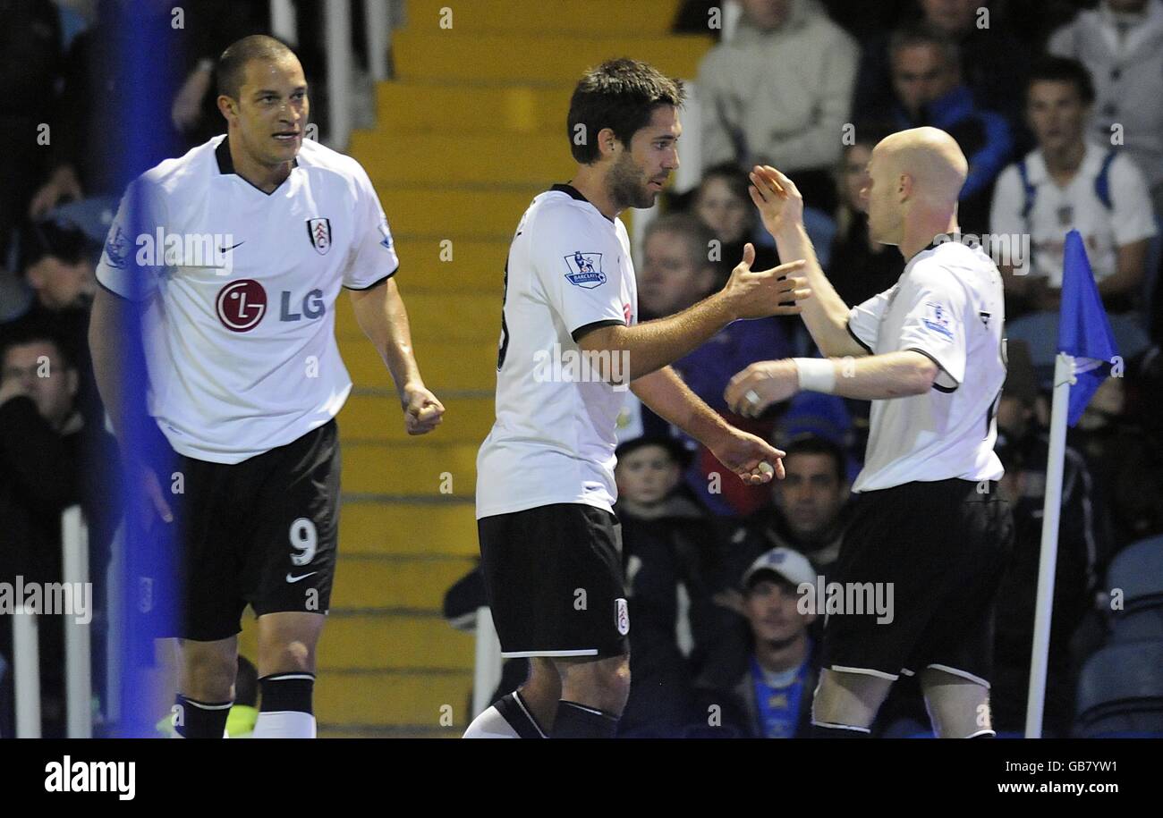 Fulham's Clint Dempsey (centre) celebrates with team mate Andrew Johnson (right) after scoring the second goal of the game. Stock Photo