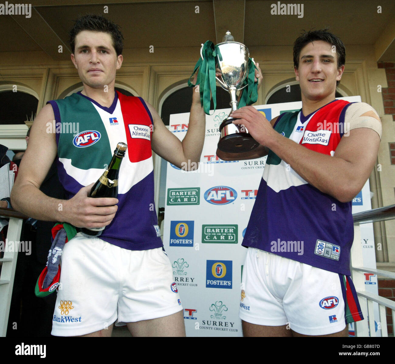 Freemantle Dockers 'Man Of The Match' Justin Longmuir and Captain Matthew Pavlich with the Bartercard AFL Challenge Trophy Stock Photo