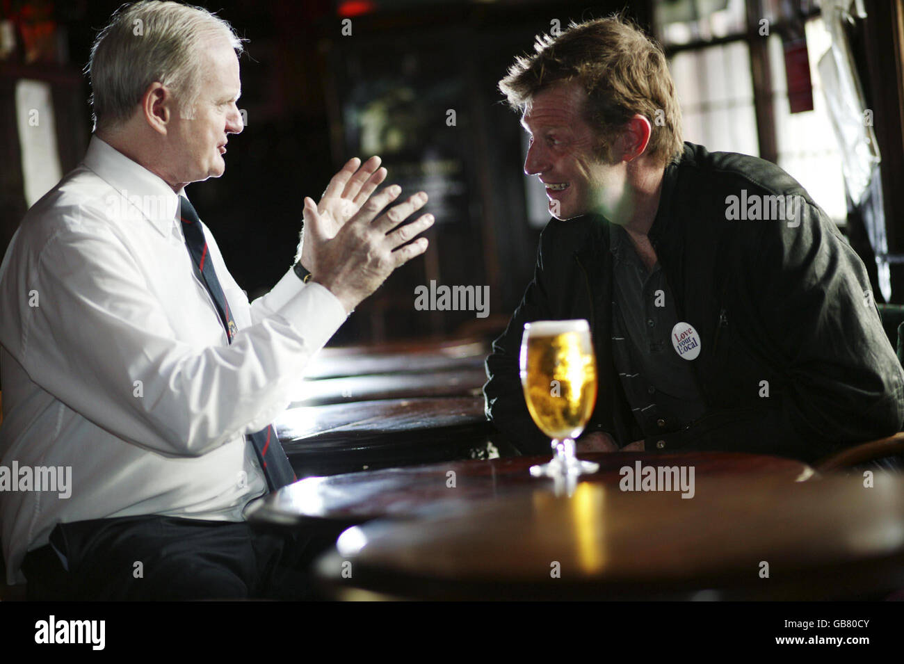 Landlord Gerry O'Brien, winner of the Stella Artois Love Your Local campaign and actor Jason Flemyng inside The Churchill Arms on Kensington Church Street, London. Stock Photo