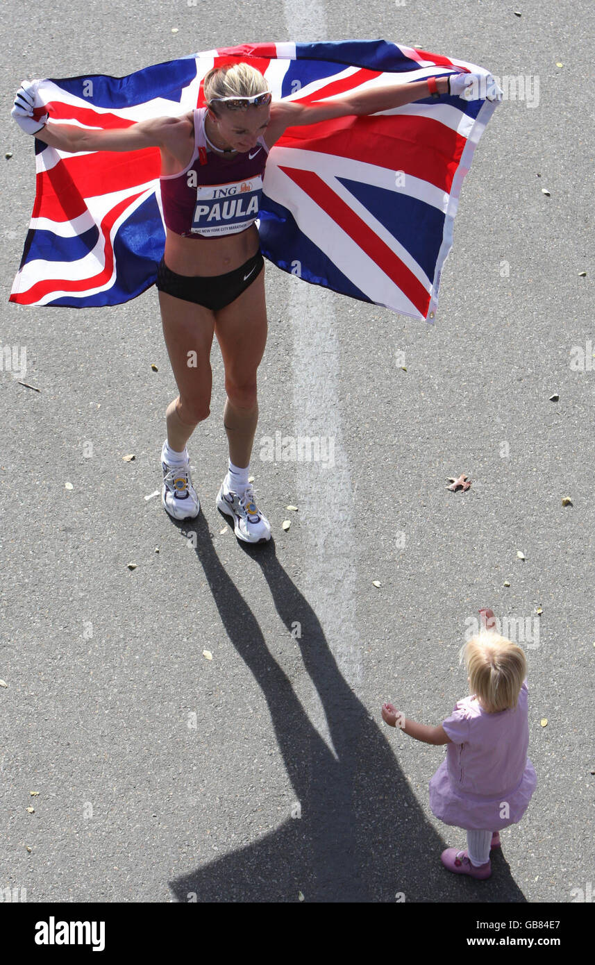 Great Britain's Paula Radcliffe celebrates her win with her daughter Isla following victory in the New York Marathon, New York, USA. Stock Photo