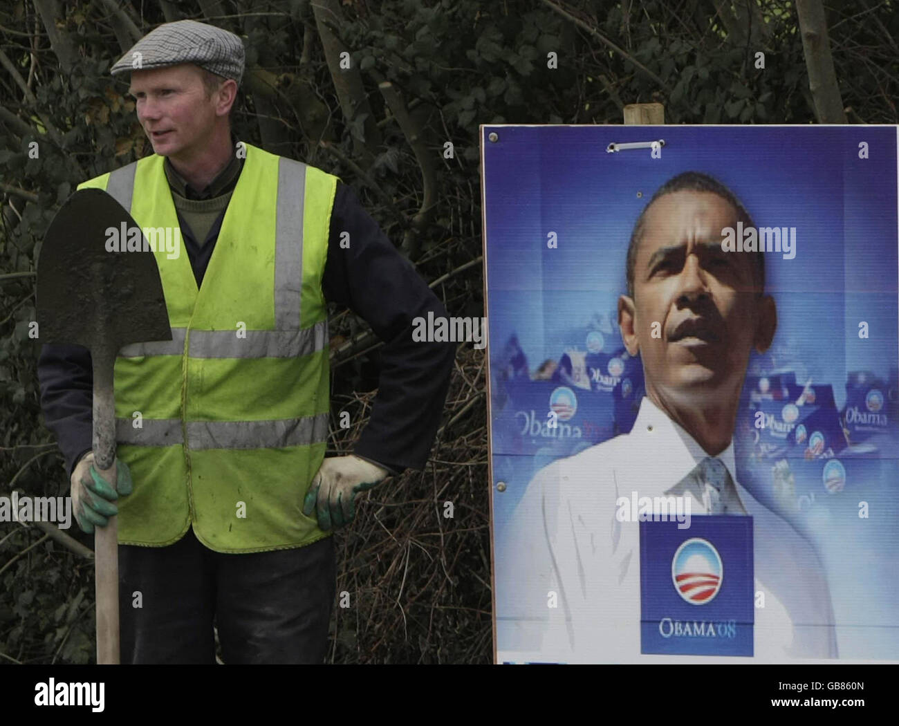 A council worker stands next to a sign of U.S presidential hopeful Barack Obama, in the small village of Moneygall, in Co. Offaly, Obama's ancestral home, discovered through church records. Stock Photo