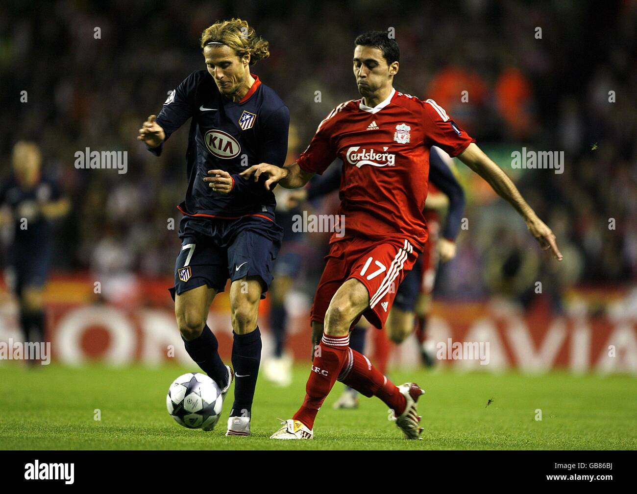 Soccer - UEFA Champions League - Group D - Liverpool v Atletico Madrid - Anfield. Atletico Madrid's Diego Forlan (l) and Liverpool's Alvaro Arbeloa battle for the ball Stock Photo