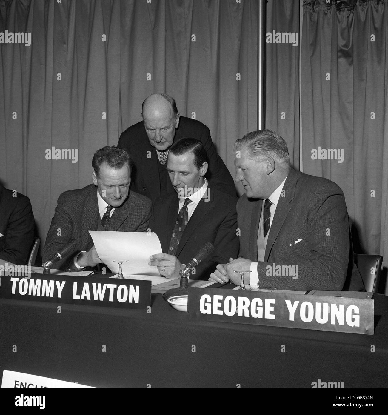 Lord Brabazon of Tara, the 78 year old chairman, looks over the shoulders of the three men of the panel. Left to right, seated: Tom Finney, formerly of Preston North End; Tommy Lawton, the great England centre-forward and George Young, the former Scottish international full-back. Stock Photo