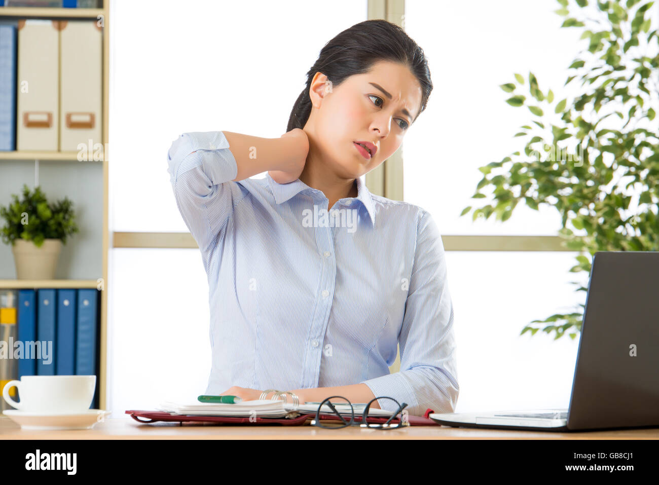 Young asian business woman with pain in neck in office Stock Photo - Alamy