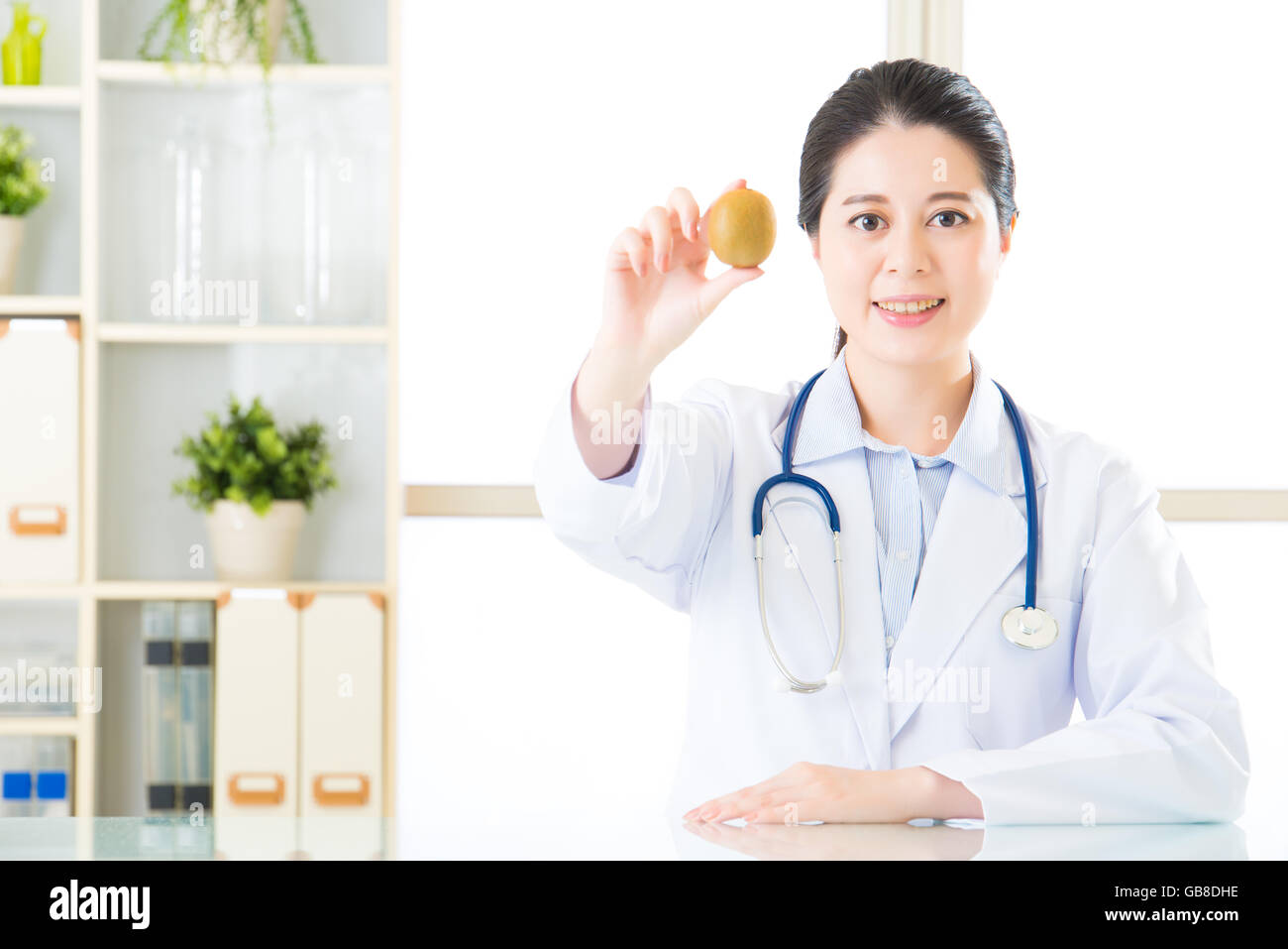 Young asian nutritionist holding a kiwi hi-res stock photography and ...