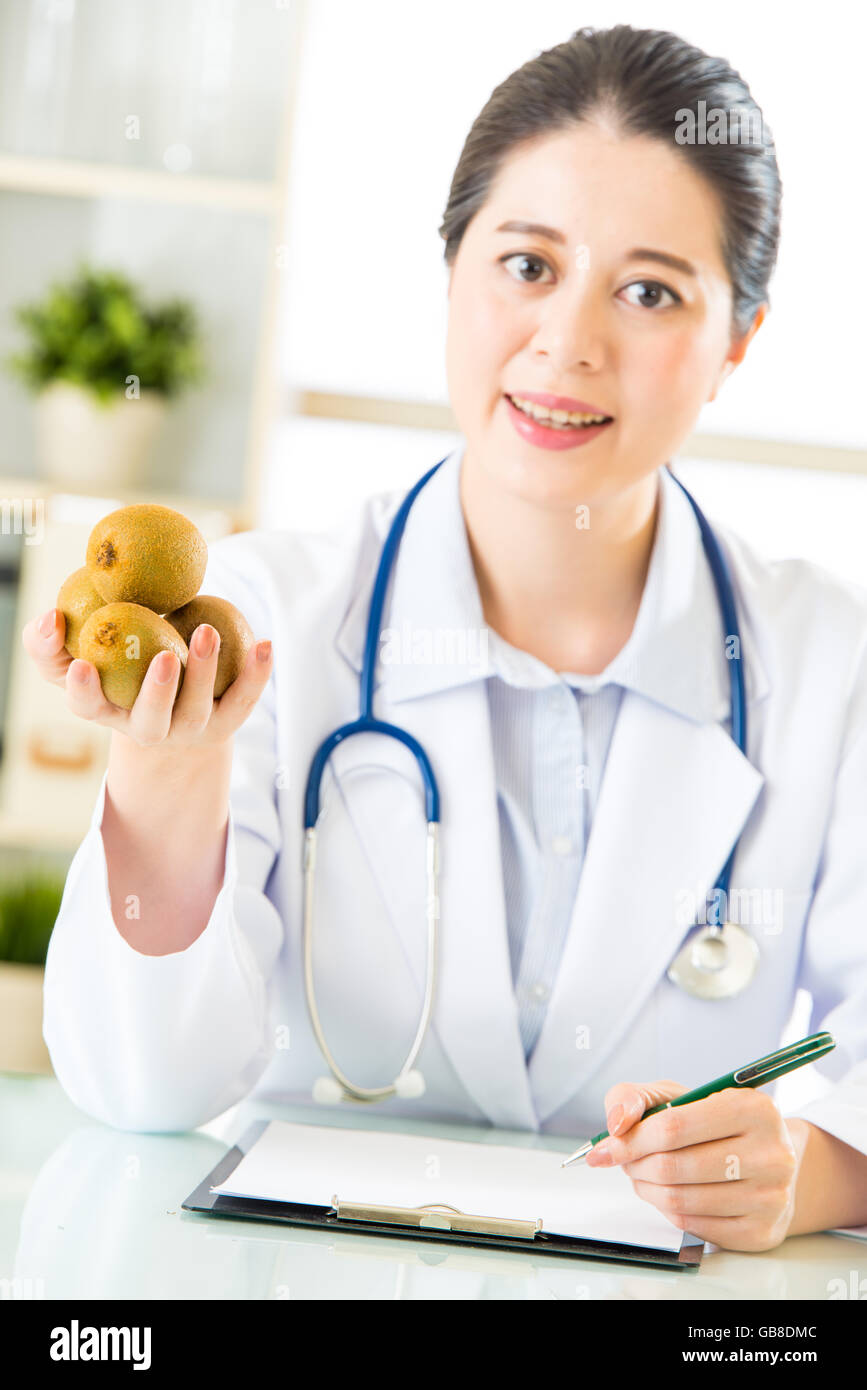 Young asian nutritionist doctor writing diet plan, kiwi Stock Photo - Alamy