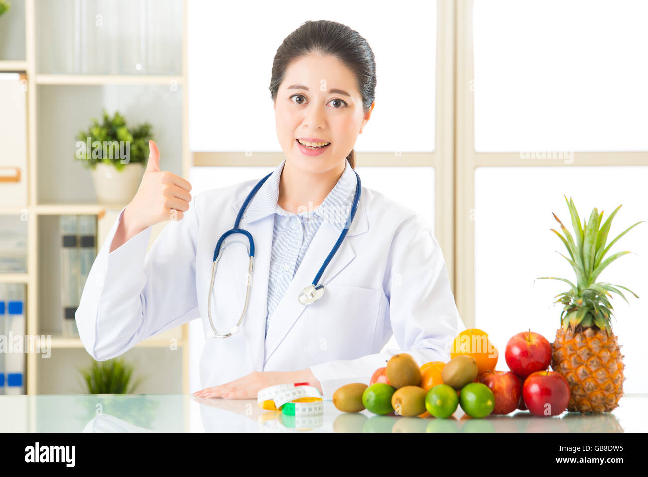Young asian nutritionist eating an apple hi-res stock photography and ...