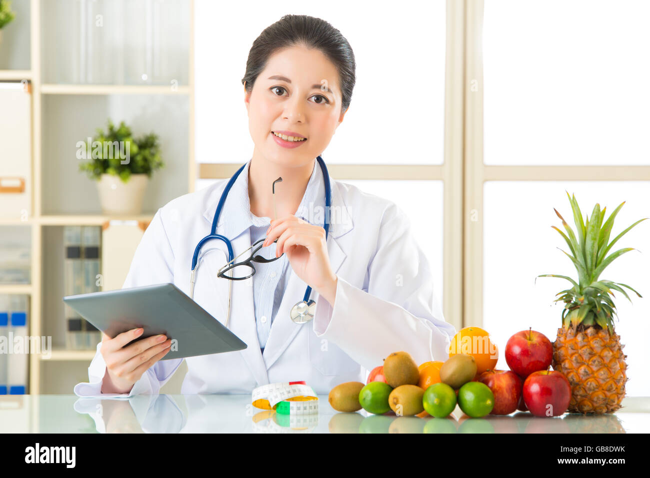 Young asian nutritionist eating an apple hi-res stock photography and ...