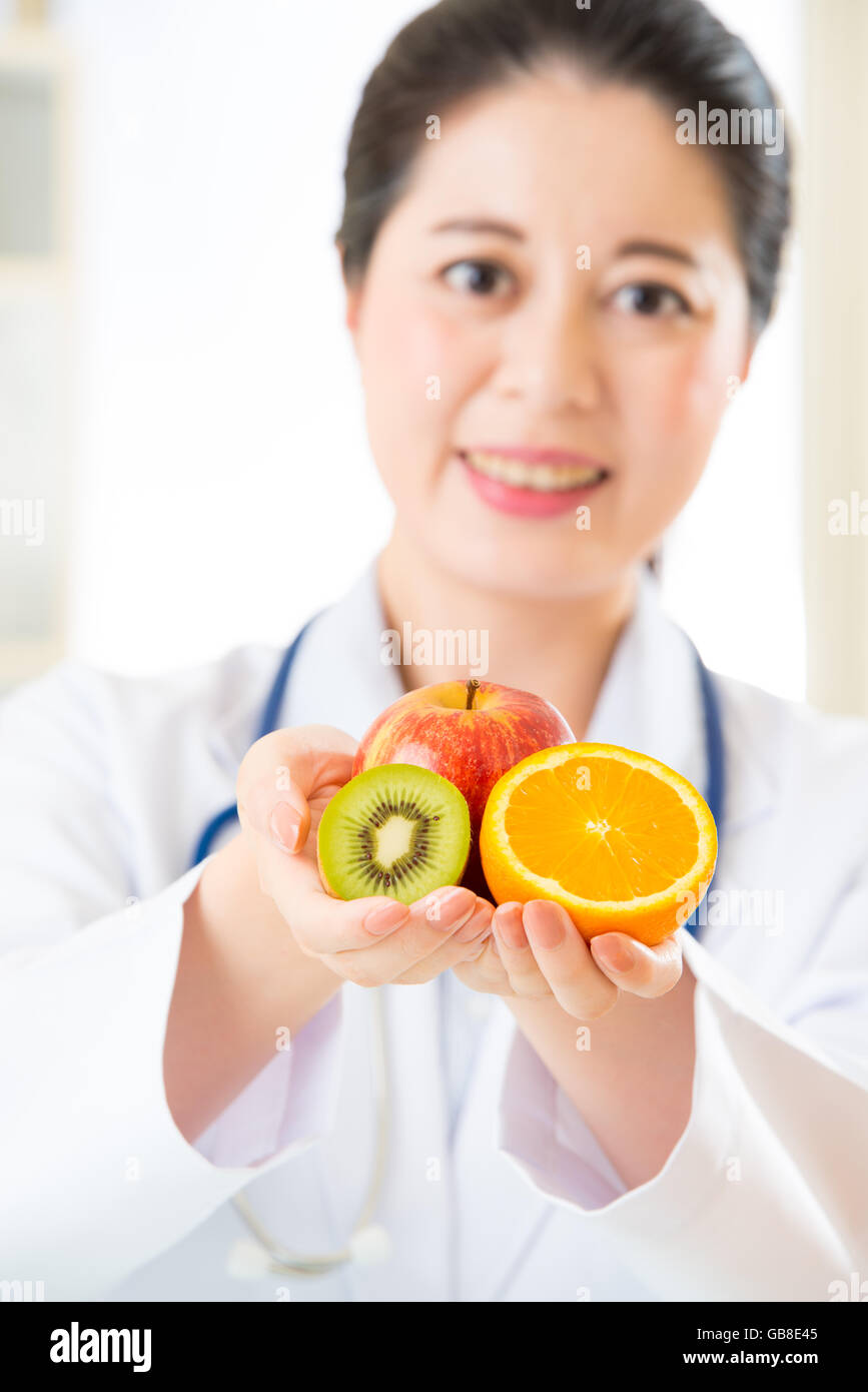Young asian nutritionist eating an apple hi-res stock photography and ...