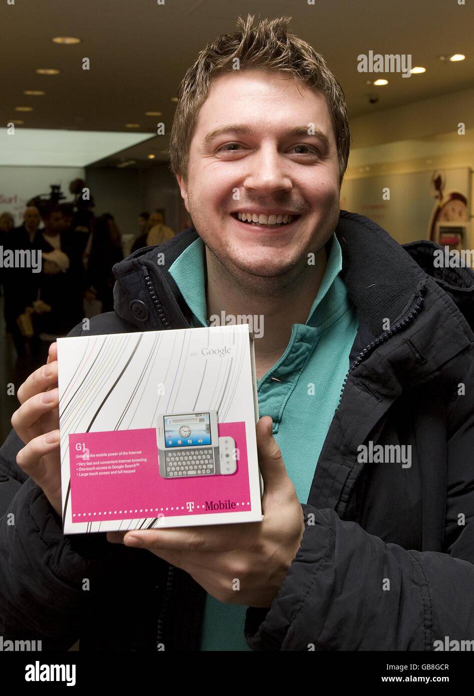 Andy Burgess, a software developer from London becomes the first person in the UK to buy a T-Mobile G1 mobile phone after it went on sale for the first time in the UK today, at the T-Mobile store in Oxford Street, London. Stock Photo