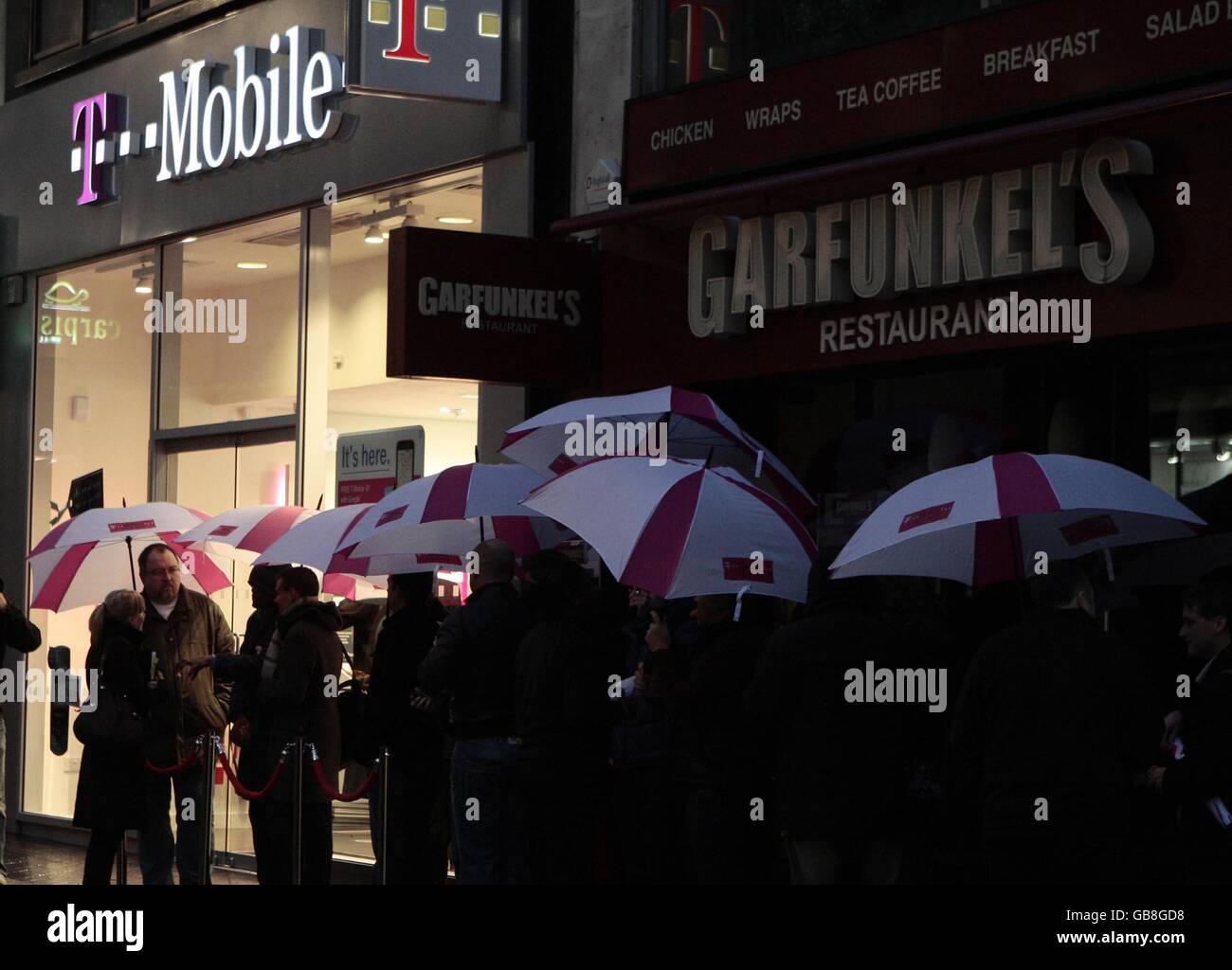 Shoppers queue outside the T-Mobile store on Oxford Street, London in a bid to become the first people in the UK to own the new T-Mobile G1 mobile phone as it goes on sale for the first time today in the UK. Stock Photo