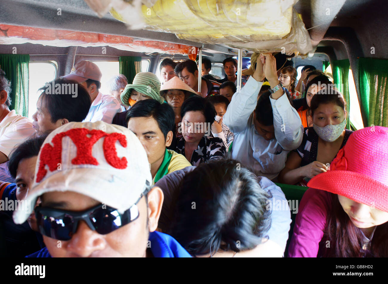 People sit in overcrowded, packed like sardines with number of passenger over assign, they look unhappy on non-stop express pass Stock Photo