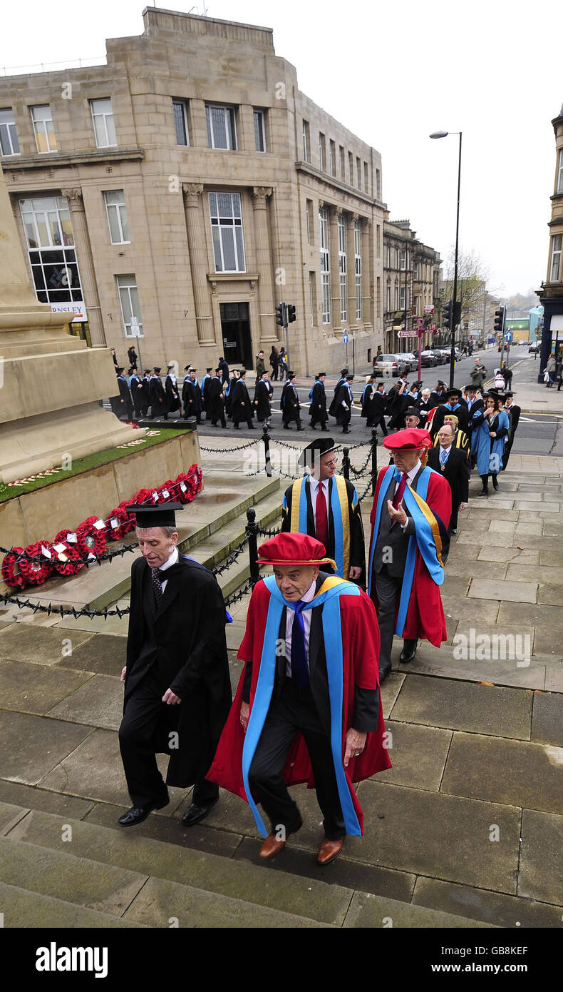 Dickie Bird (right, front) and Sir Michael Parkinson (right, back) and at the Huddersfield University campus in Barnsley, where they received honorary doctorates. Stock Photo