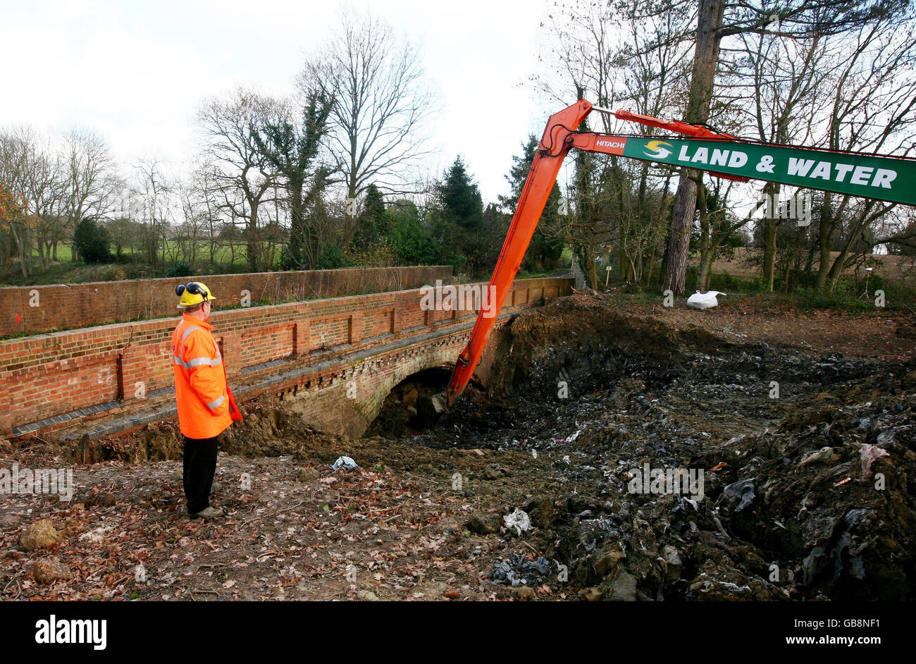 An engineer watches a digger excavate thousands of tonnes of waste