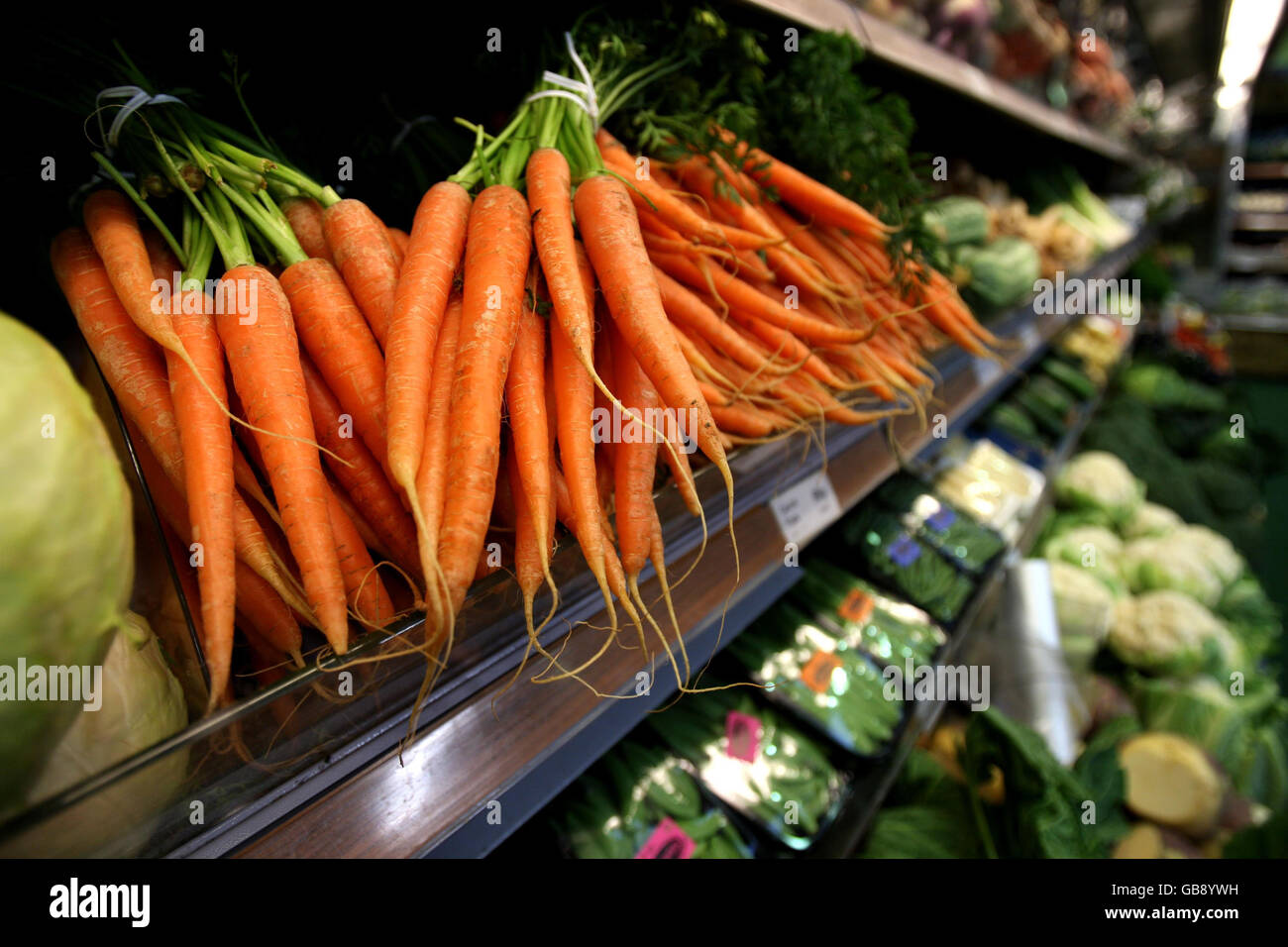 Carrots on display at Coton Farm Shop in Cambridgeshire. Curvy cucumbers and nobbly carrots will be back on sale in the shops from next July if, as expected, more than two dozen laws banning imperfect-looking fruit and veg are scrapped today. Stock Photo