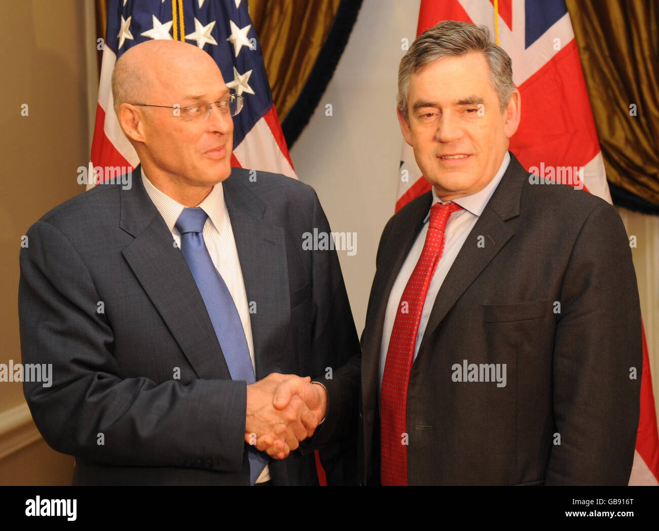 Prime Minister Gordon Brown shakes hands with U.S. Treasury Secretary Hank Paulson at the U.S. Treasury in Washington. Stock Photo