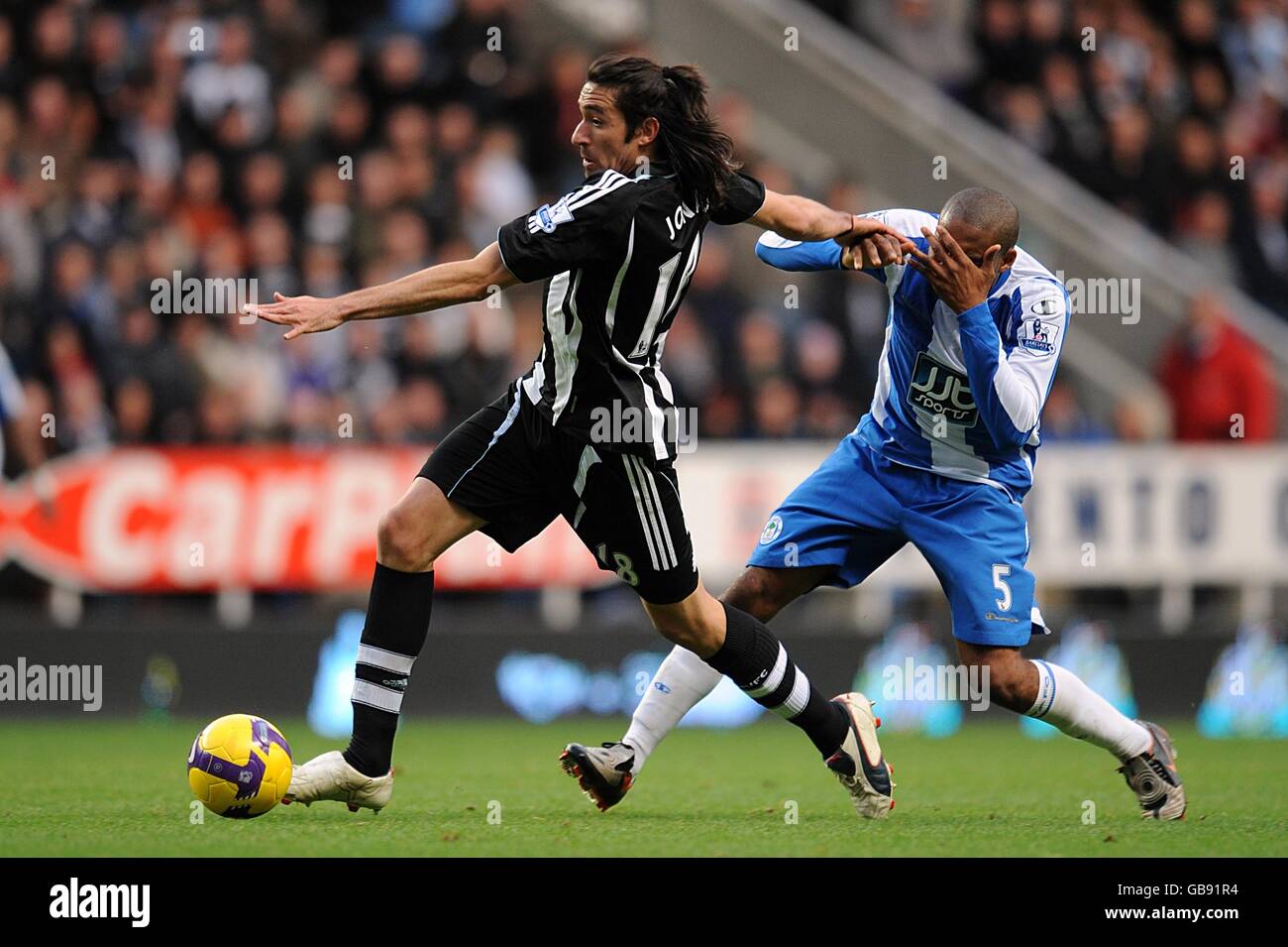 Wigan Athletic S Wilson Palacios Is Caught By The Elbow Of Newcastle United S Jonas Gutierrez Left Stock Photo Alamy