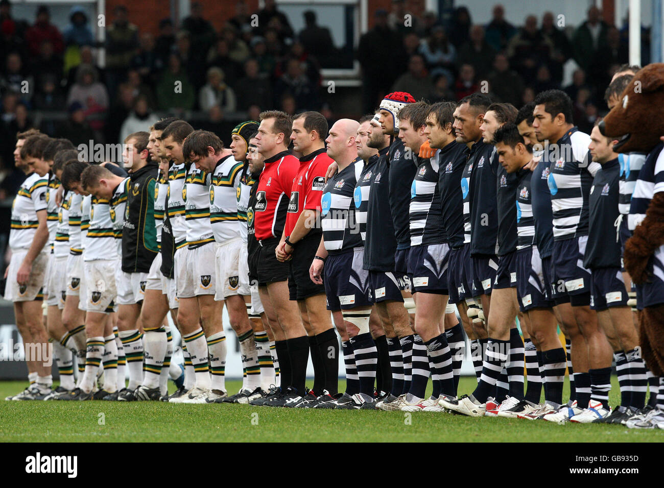 The Bristol Rugby and Northampton Saints players stand together for a