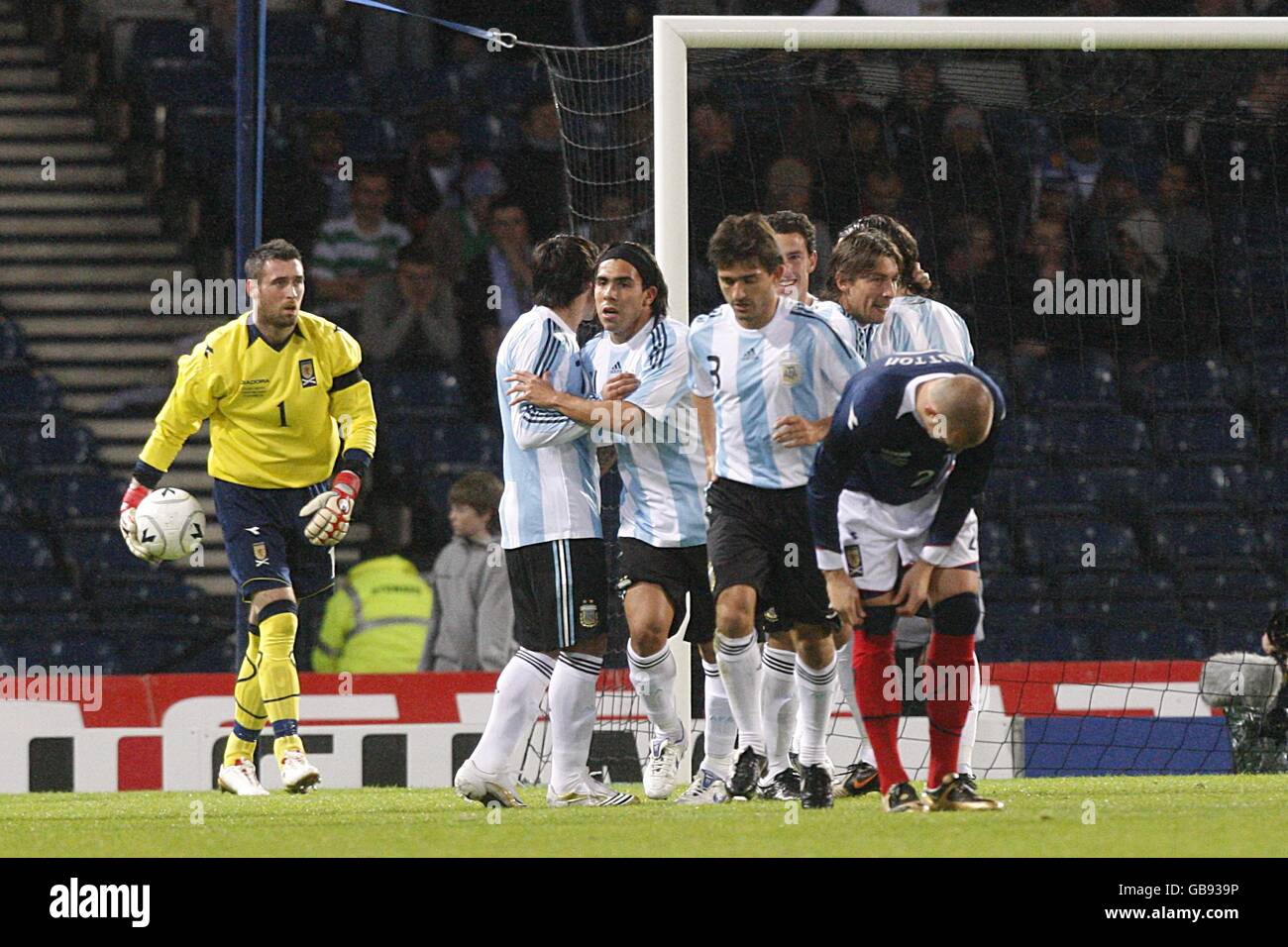 Argentina players celebrate with goalscorer Maximiliano Rodriguez (centre left) after scoring their first goal of the game as Scotland goalkeeper Allan McGregor and Alan Hutton (front) react Stock Photo