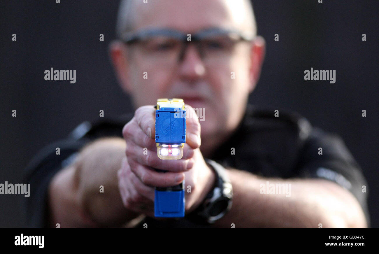PC Terry Allan demonstrates a Taser stun gun during at at the Police Headquarters in Ponteland, England. Stock Photo