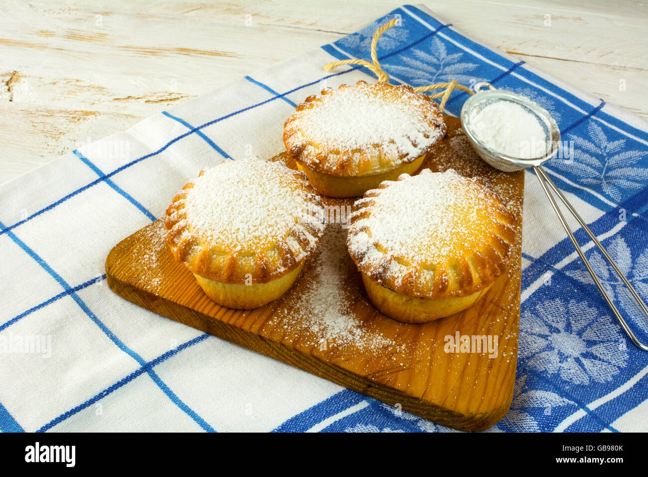 Small confiture pies and baking sieve. Jam pie. Small pie. Pie. Sweet pastry. Sweet dessert Stock Photo