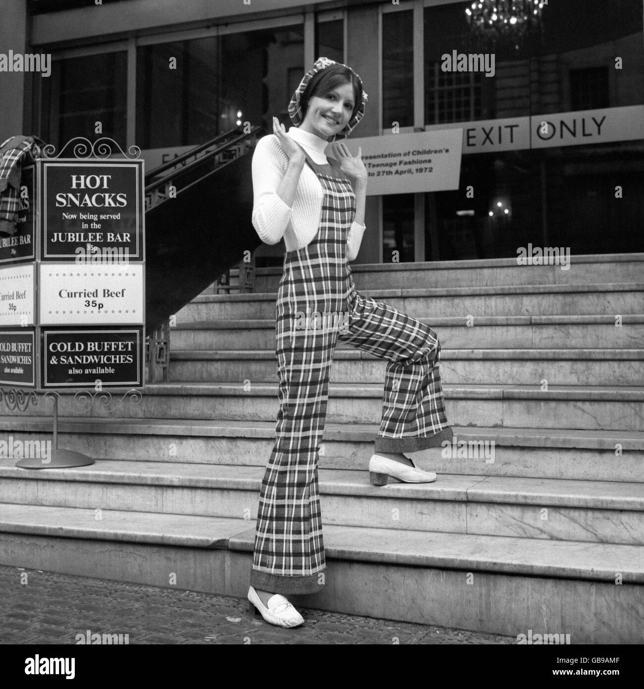 Dungarees in a check design worn with a polo-neck jumper by Anne Corfield. They were shown at a presentation of children's and teenage fashion. Stock Photo