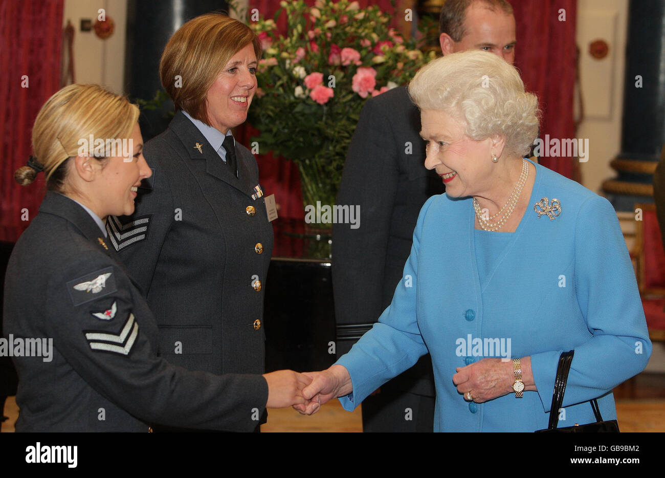Britain's Queen Elizabeth II talks to (left to right) Corporal Audrey McKenna from the RAF Paramedic Deployable Aeromedical Response Team, and Flight Sergeant Karen McNeill, Flight Nurse in the RAF Aeromedical Evacuation Squadron, during a reception at Buckingham Palace in London, for people working in Healthcare in the UK. Stock Photo