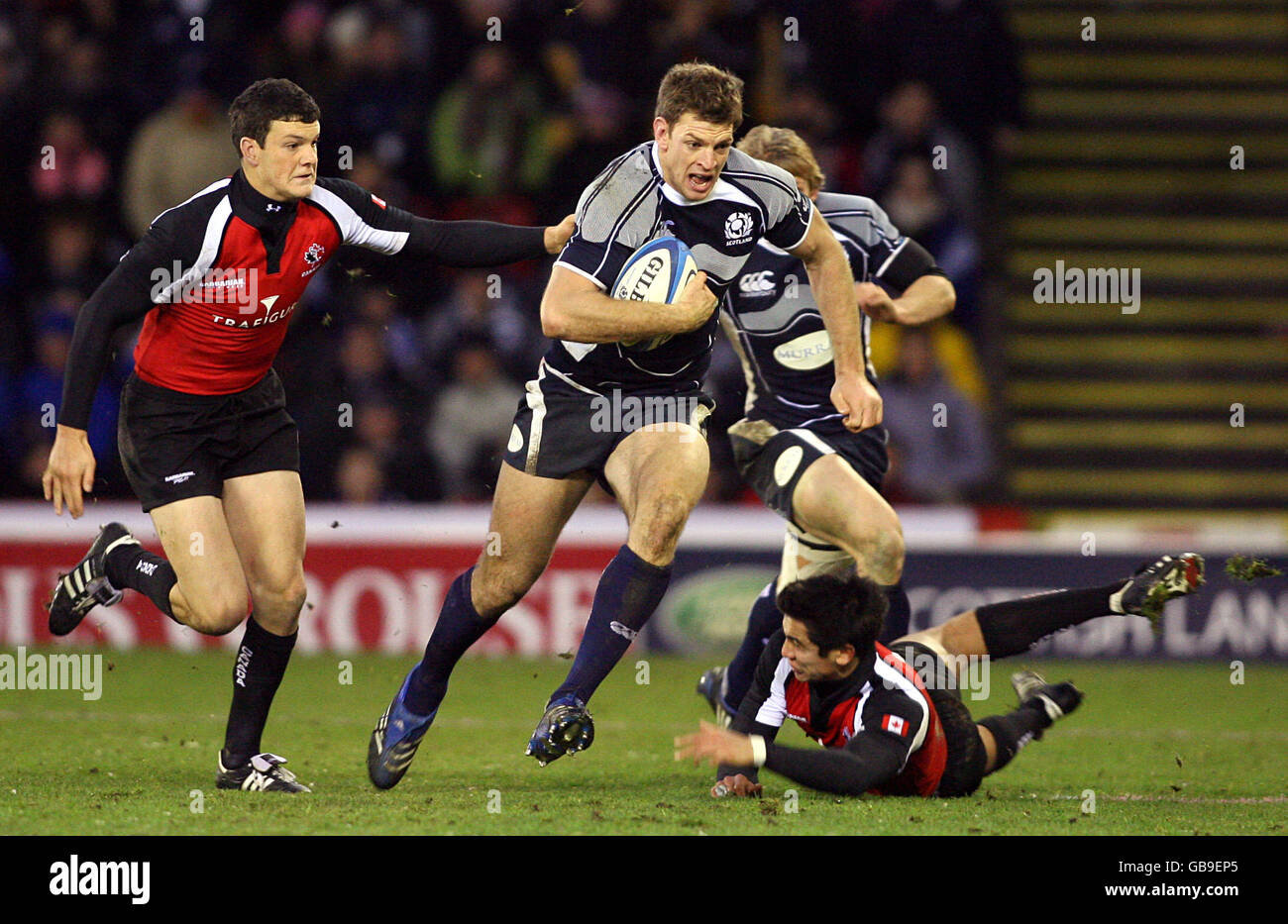 Scotland's Nikki Walker (centre) fights his way past the Canadian defence. Stock Photo